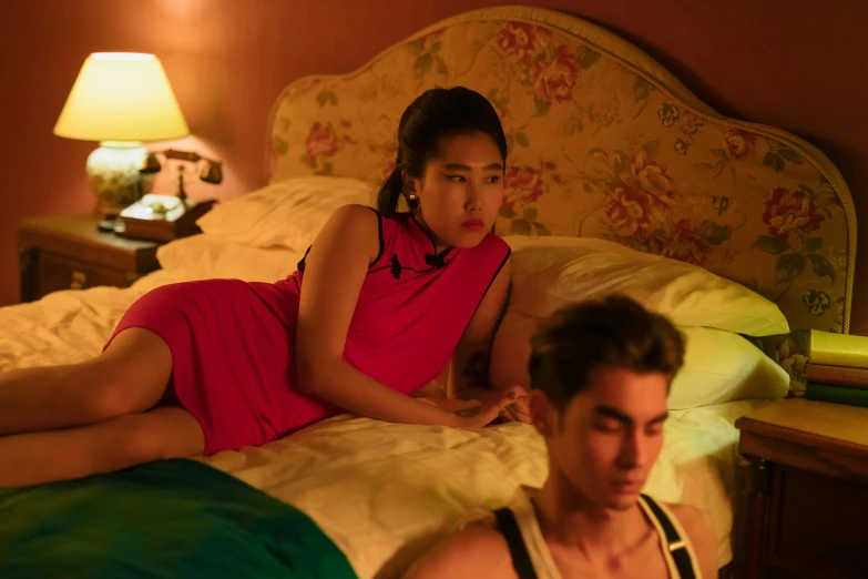 a woman laying on top of a bed next to a man, janice sung, pretty face sharp chine, brightly coloured, netflix