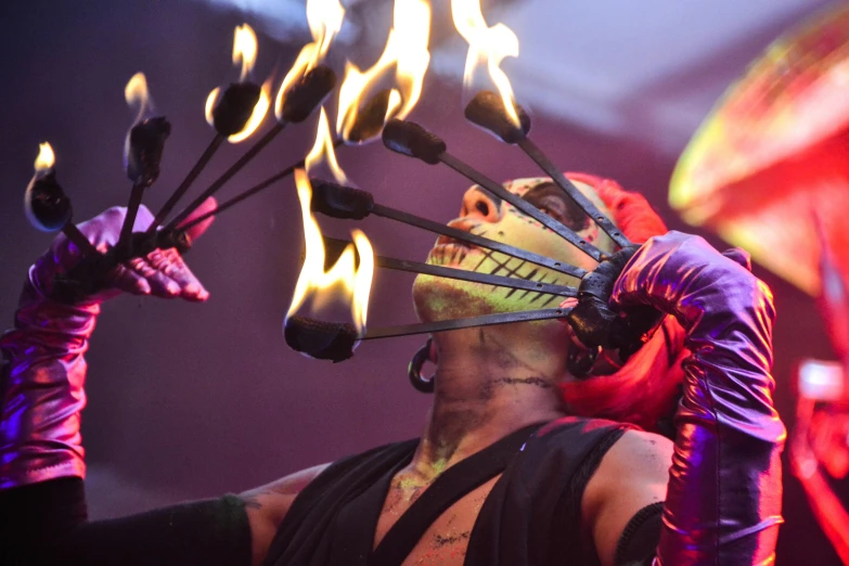 a close up of a person with fire on their head, performing on stage, dark goddess with six arms, male jester, evil vibe
