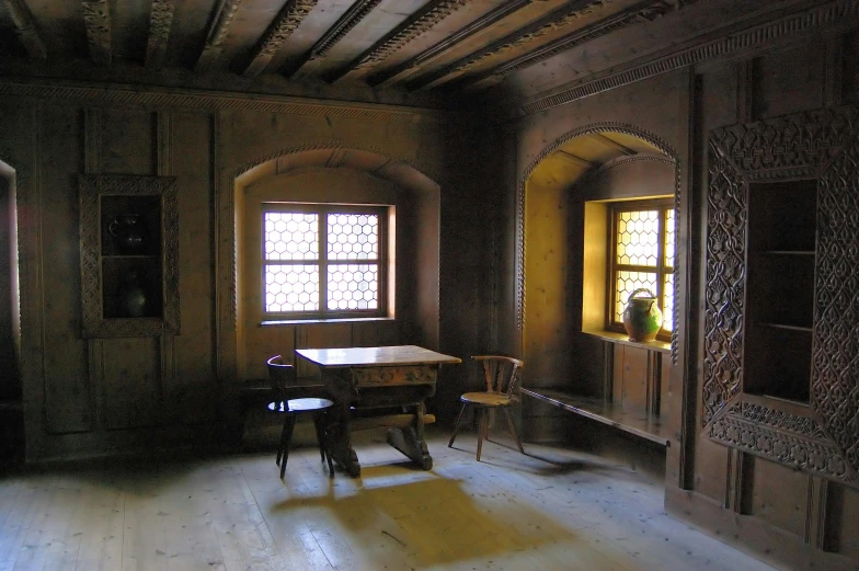 a room with a table and chairs in it, a photo, flickr, renaissance, wooden buildings, brown, plaster, wikimedia