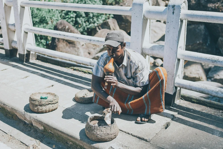 a man that is sitting on some steps, mortar and pestle, afar, on a bridge, carefully crafted