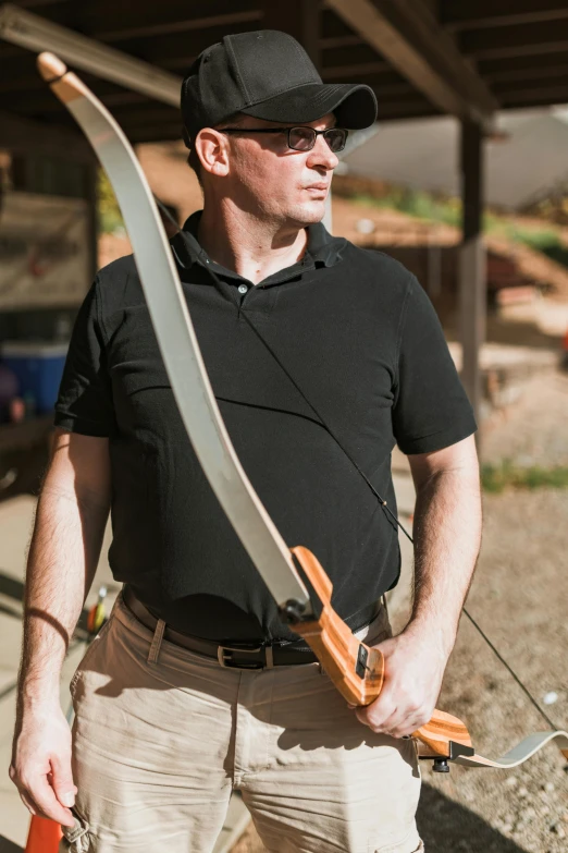 a man is holding a bow and arrow, inspired by Graham Forsythe, wearing polo shirt, holding pdw, profile image, cotton