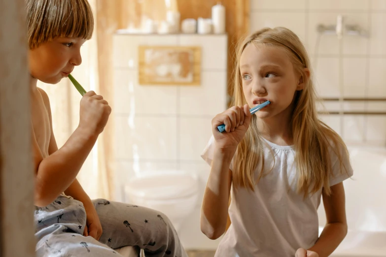 two children brushing their teeth in a bathroom, pexels contest winner, happening, profile image, enhanced, brown, 1 2 9 7