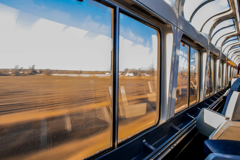 a view of a field through the window of a train, by Jan Rustem, unsplash, graffiti, high speed trains, from wheaton illinois, thumbnail, panoramic