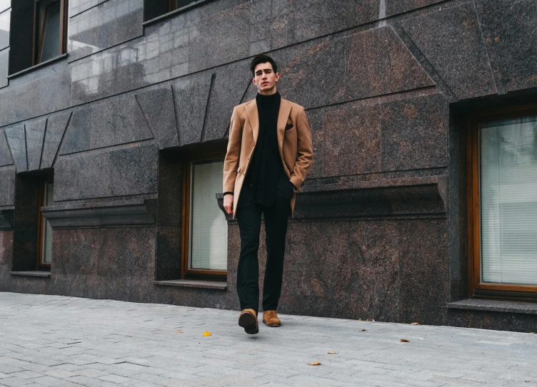 a man standing on a sidewalk in front of a building, pexels contest winner, in style of kyrill kotashev, black and brown, jovana rikalo, style of alexander trufanov