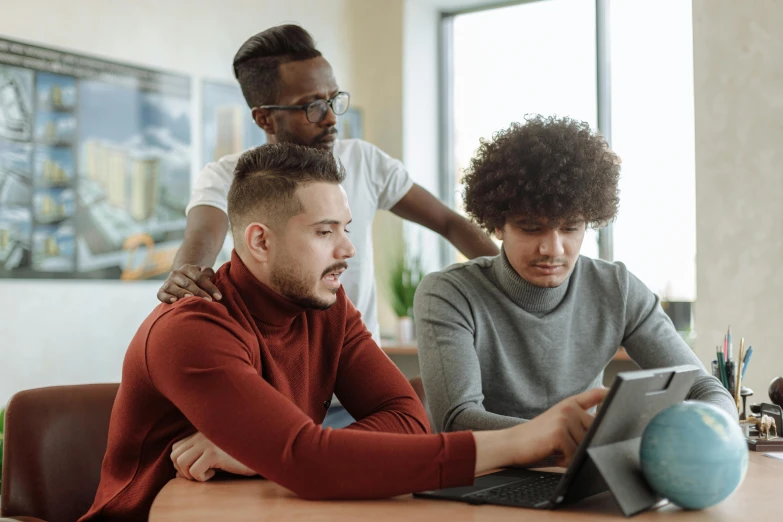 a group of people sitting around a table looking at a tablet, trending on pexels, renaissance, future coder man looking on, coloured, looking at monitor, brown