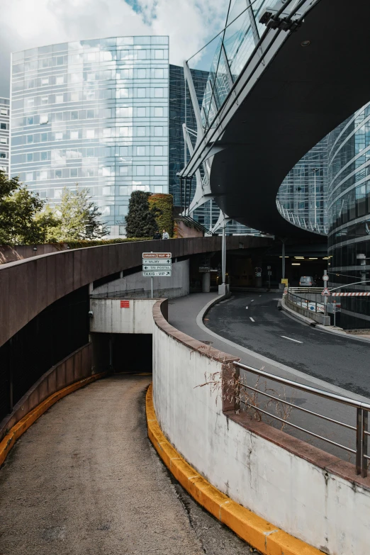 a man riding a skateboard up the side of a ramp, inspired by Zaha Hadid, unsplash contest winner, european japanese buildings, cars parked underneath, empty streetscapes, tunnel