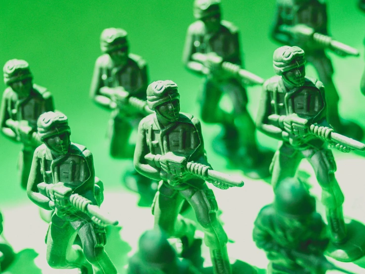 a group of toy soldiers standing next to each other, by Adam Marczyński, sickly green colors, cyber war, promo image, soldiers charging in