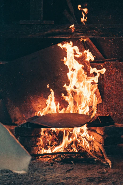 a pizza oven with flames coming out of it, an album cover, trending on unsplash, renaissance, blacksmith, wok, high quality photo, patina