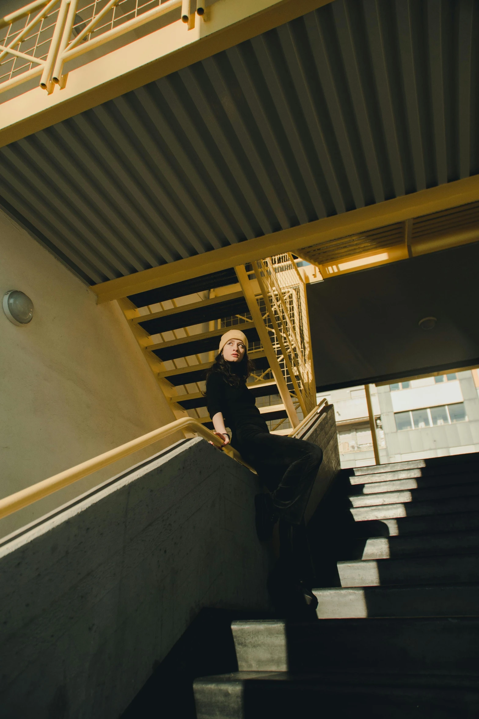a man riding a skateboard down a flight of stairs, an album cover, by Nina Hamnett, unsplash, modernism, johan liebert, looking away from camera, student, standing in a dimly lit room