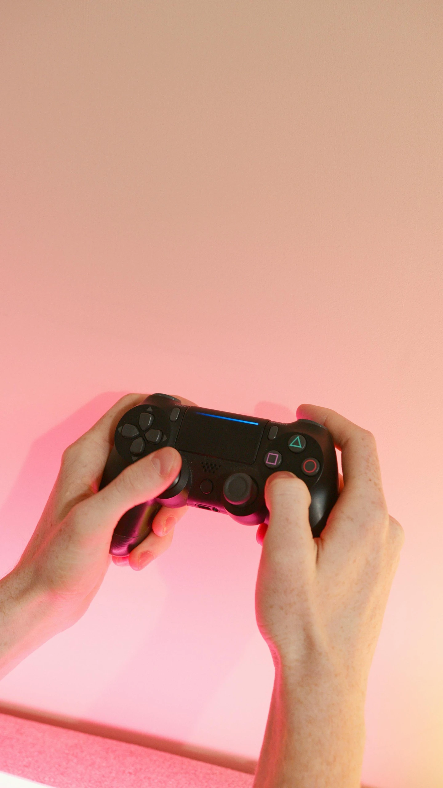 a person holding a video game controller in their hands, by Carey Morris, pexels, conceptual art, pink hue, playstation 4, flat minimalistic, low quality photo