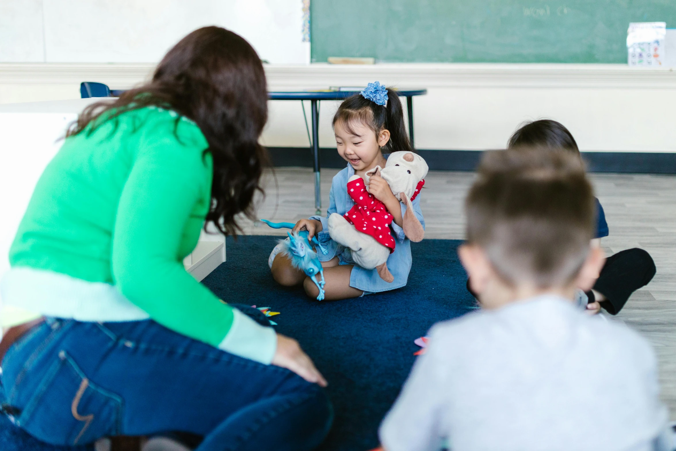 a group of children sitting on the floor playing with stuffed animals, pexels contest winner, danube school, standing in class, te pae, 40 years old women, profile image