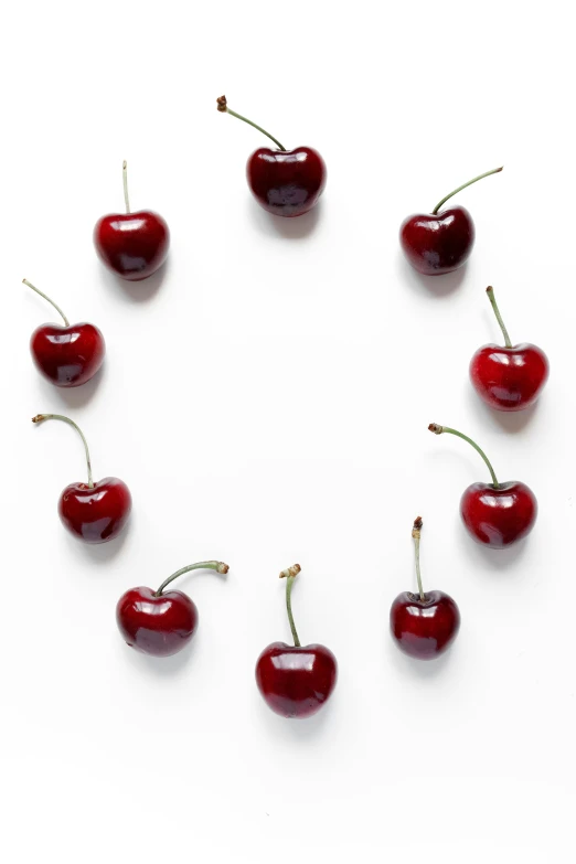 a circle of cherries on a white surface, photograph credit: ap, under a spotlight, hearts, promo image