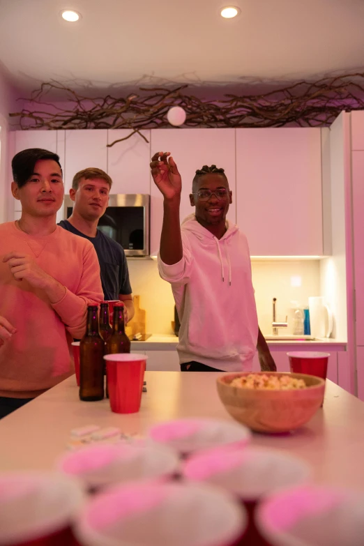 a group of men standing around a kitchen counter, happening, bisexual lighting, decorations, cheers, digital pong screen