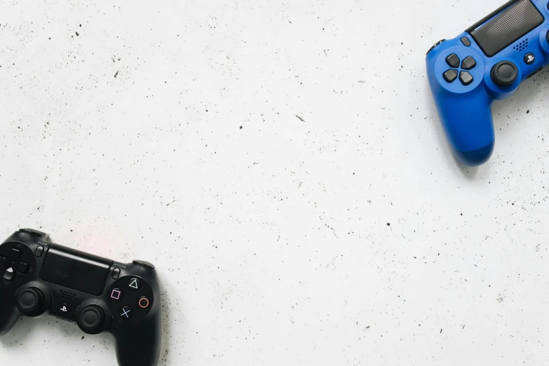 a couple of video game controllers sitting next to each other, a picture, unsplash, minimalism, on a white table, 15081959 21121991 01012000 4k, blue and black, headshot