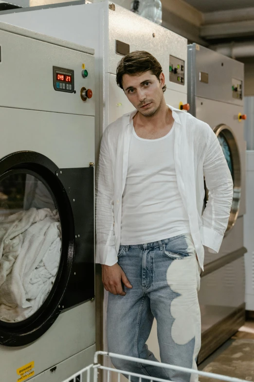 a man standing in front of a washing machine, inspired by Luca Zontini, pexels contest winner, renaissance, wearing a white button up shirt, attractive young man, dressed in a worn, pr shoot