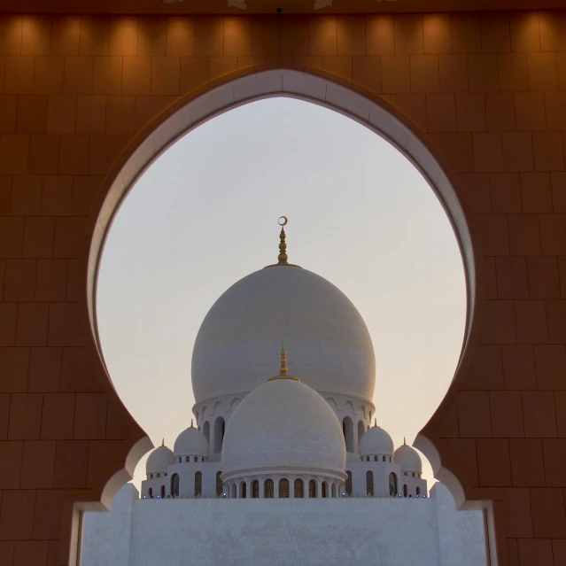 a large white building with a dome on top of it, by Sheikh Hamdullah, pexels contest winner, arabesque, herzog de meuron, archway, centered in frame, illuminating the area