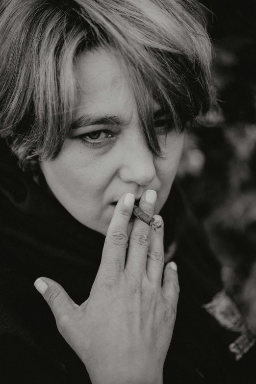 a black and white photo of a woman smoking a cigarette, inspired by Billie Waters, unsplash, visual art, frank dillane as puck, mark e smith, high quality photo, dayanita singh