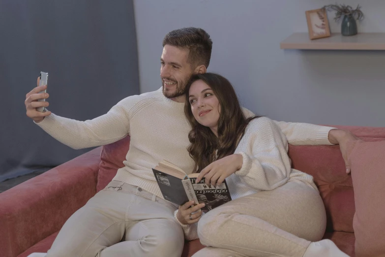 a man and a woman sitting on a couch taking a selfie, reading, youtube thumbnail, tv series, romanian