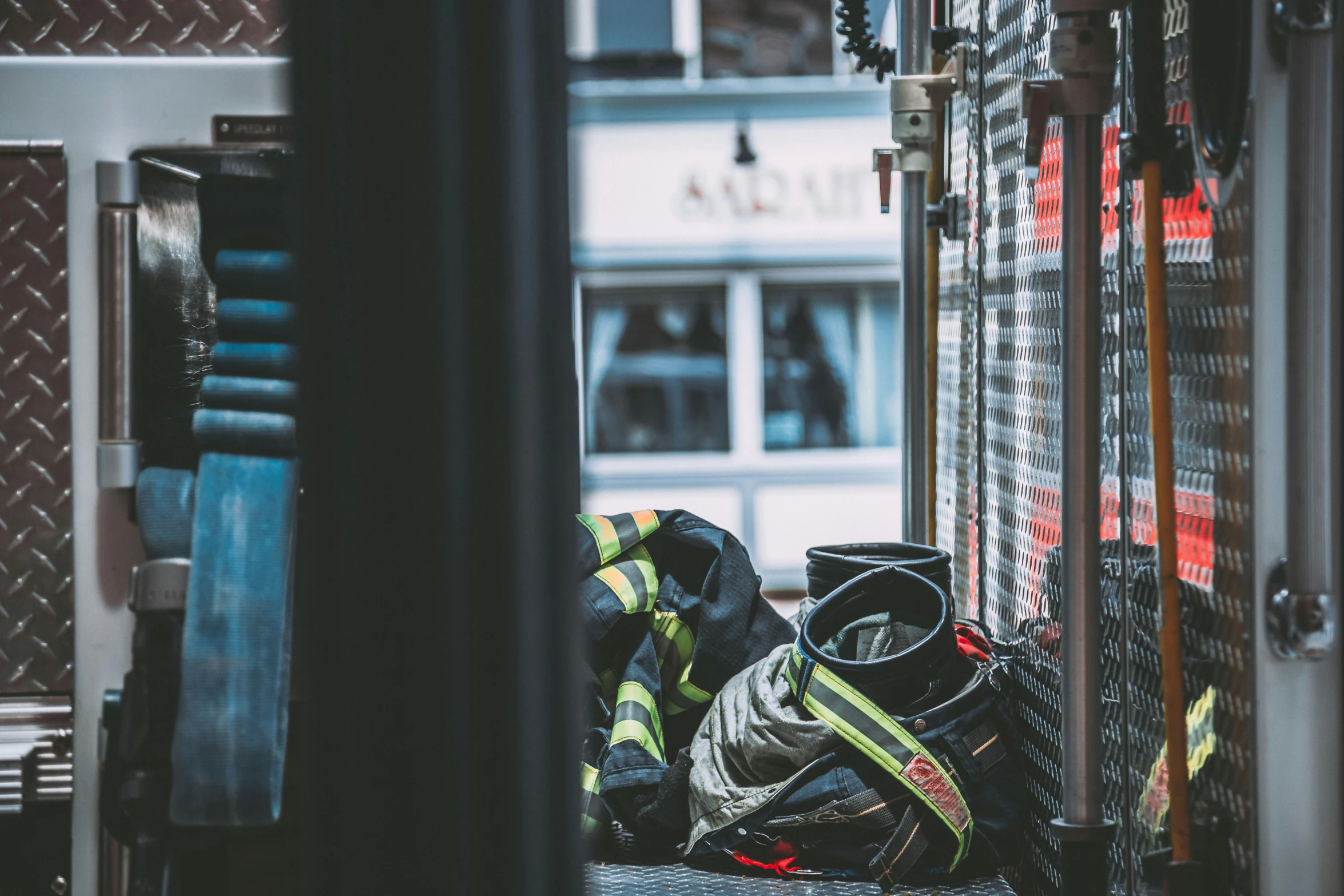 a fireman standing next to a fire truck, pexels contest winner, bags on ground, sneaker photo, fire escapes, 🚿🗝📝