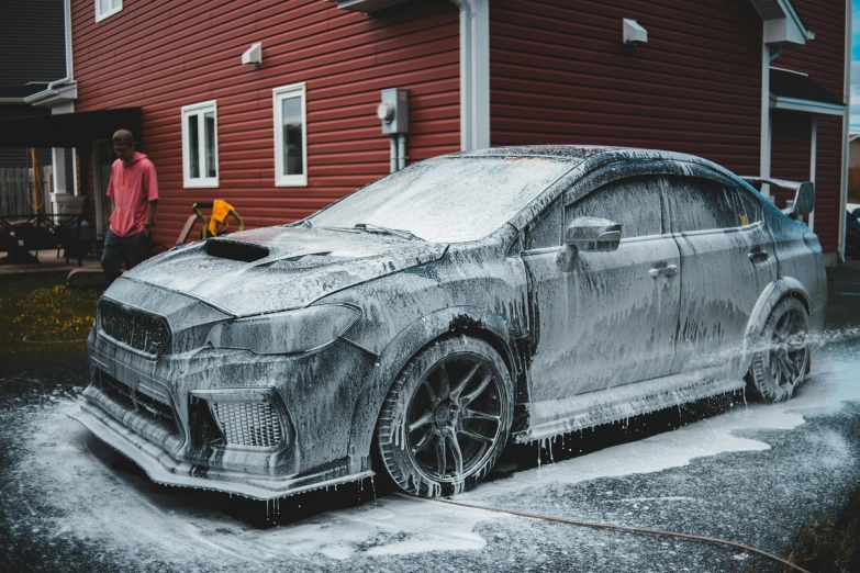 a car covered in ice in front of a red house, inspired by An Gyeon, pexels contest winner, auto-destructive art, wrx golf, covered in dust, steel gray body, casually dressed