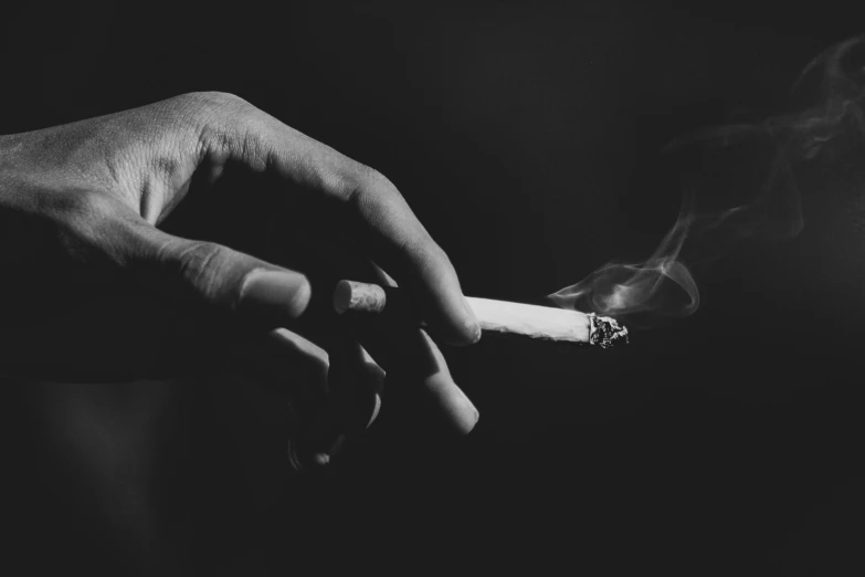 a person holding a cigarette in their hand, a black and white photo, by Kristian Zahrtmann, pexels contest winner, 15081959 21121991 01012000 4k, burning, high quality upload, mixed art