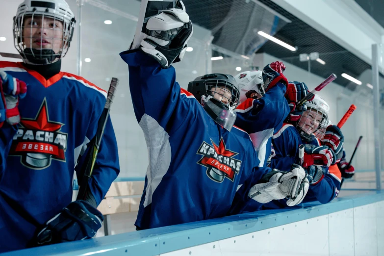 a group of young men standing on top of a hockey rink, pexels contest winner, glass helmets, novi stars, thumbnail, navy