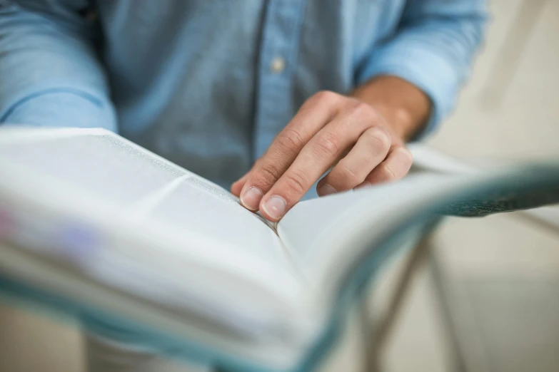 a close up of a person reading a book, on his right hand, school curriculum expert, old testament, thumbnail