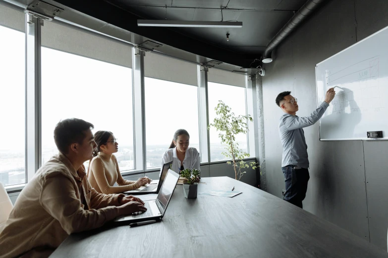 a group of people sitting around a conference table, by Adam Marczyński, standup, darren quach, in a meeting room, te pae