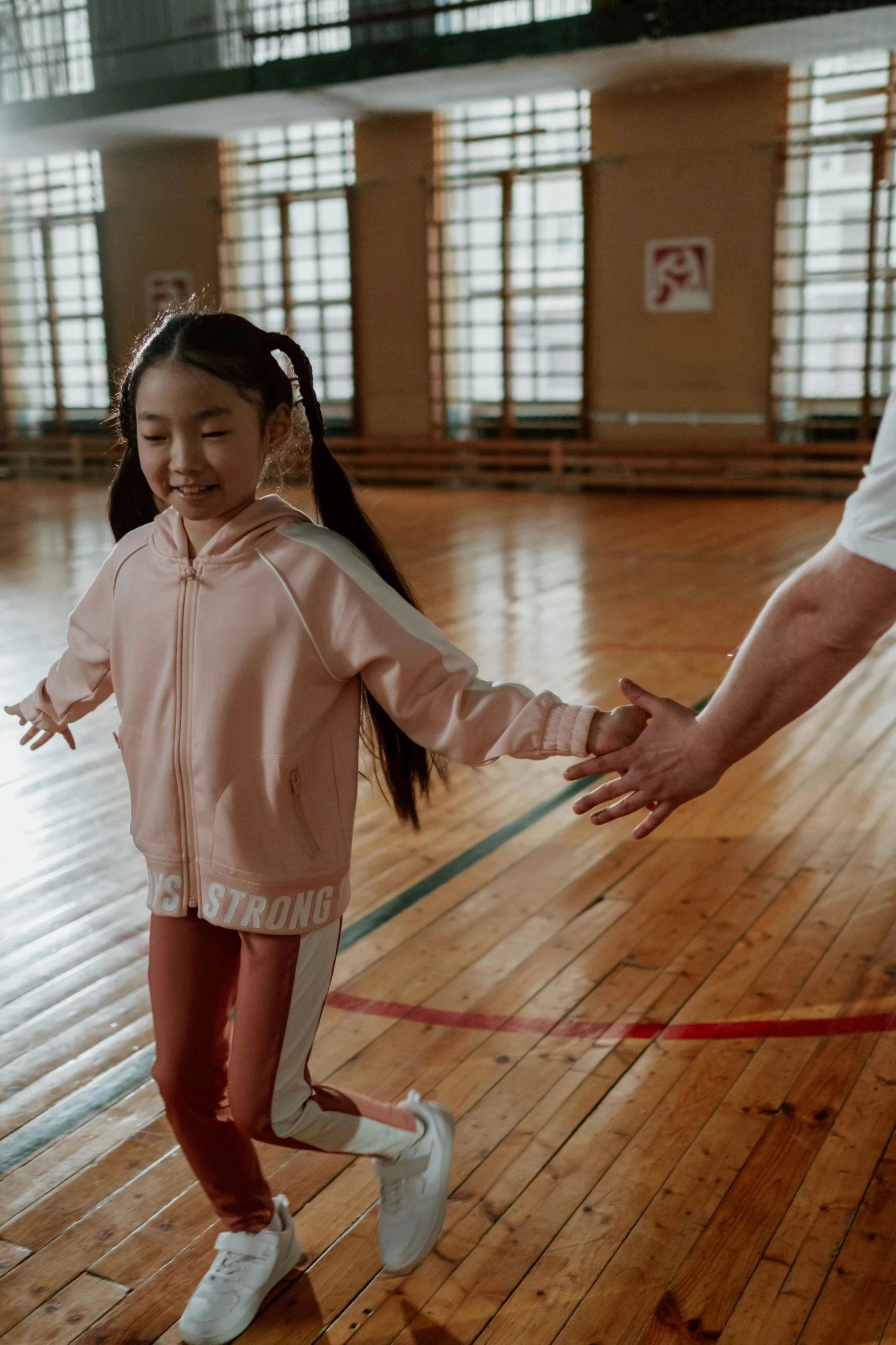 a man and a little girl holding hands in a gym, an album cover, pexels contest winner, young asian girl, ( ( theatrical ) ), film still promotional image, yulia nevskaya