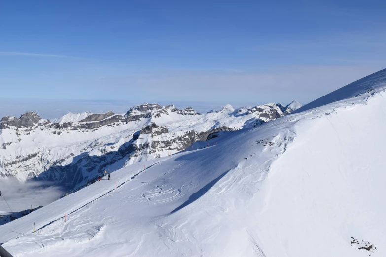 a man riding skis down the side of a snow covered slope, les nabis, clear blue skies, panoramic view of girl, avatar image