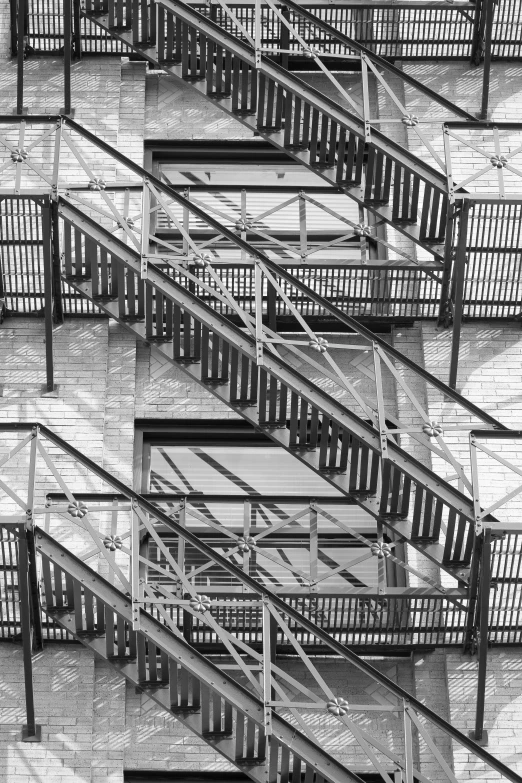 a black and white photo of a fire escape staircase, a black and white photo, inspired by MC Escher, diptych, highly abstract, two, multiple layers