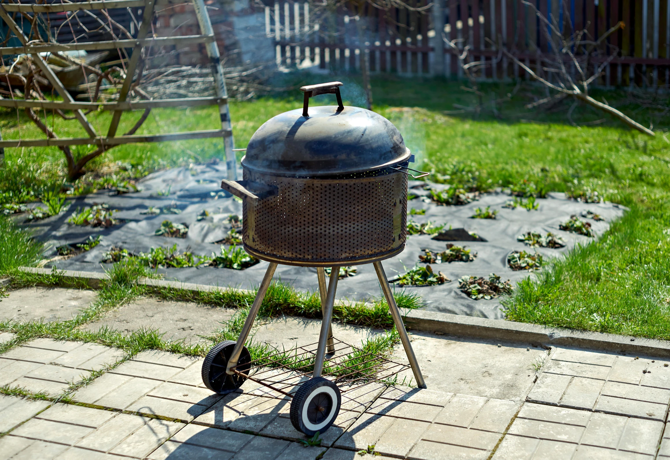 a grill sitting on top of a brick patio, auto-destructive art, pot, lawns, rusty helmet, sunny atmosphere