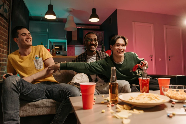 a group of young men sitting on top of a couch, pexels contest winner, happening, digital pong screen, bisexual lighting, avatar image, snacks