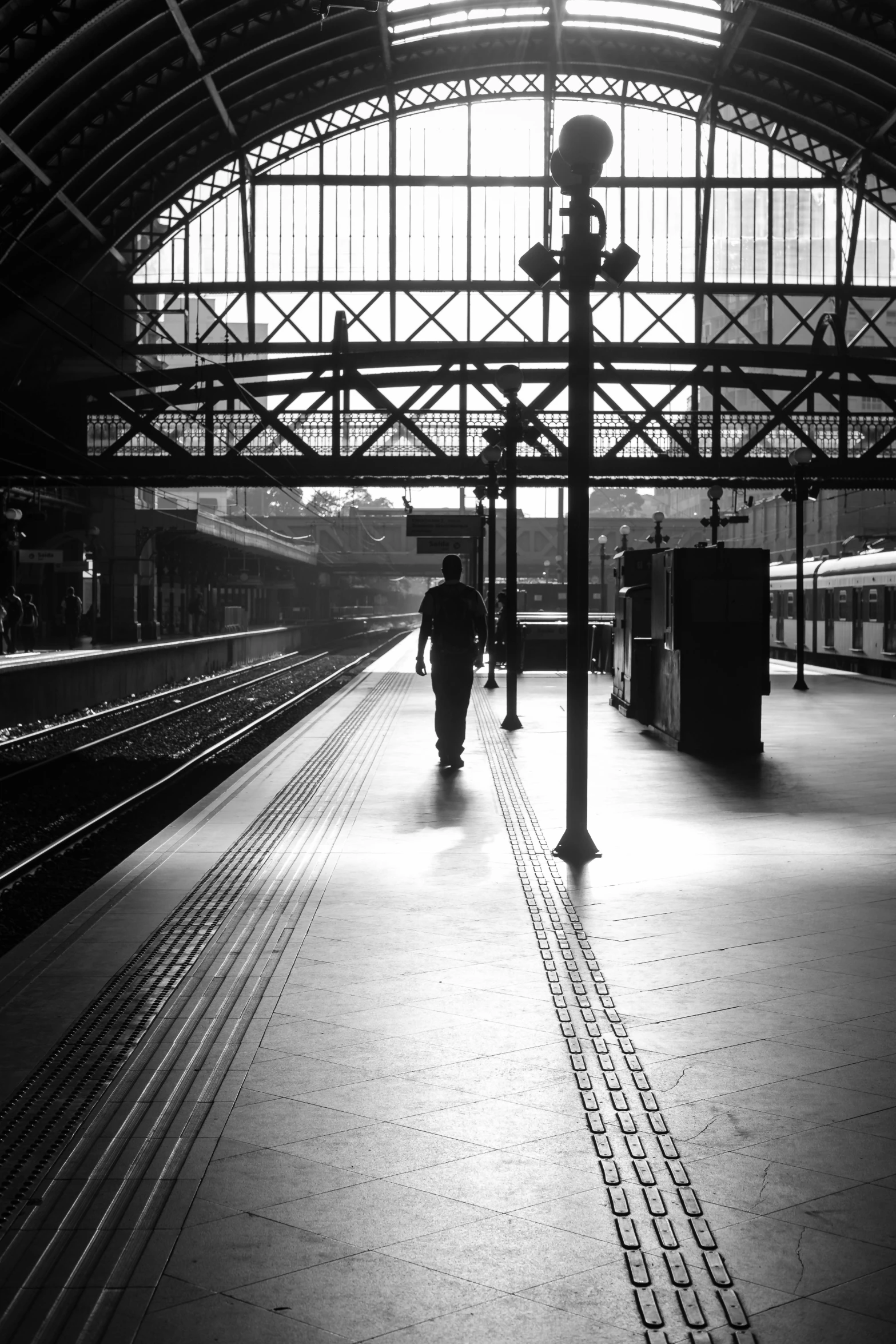 a black and white photo of a train station, :: morning, sydney, lonely rider, lonely and sad