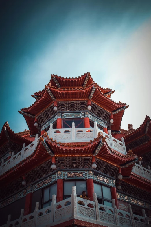 a red and white building with a blue sky in the background, a picture, inspired by An Zhengwen, pexels contest winner, cloisonnism, castles and temple details, 2 5 6 x 2 5 6 pixels, singapore, brown