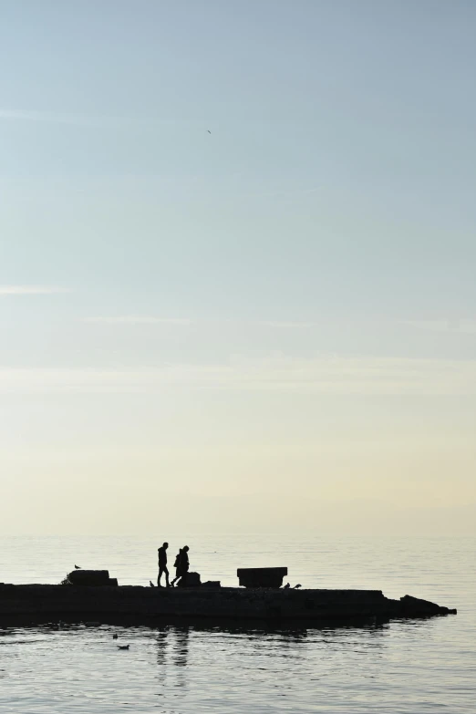 a couple of people that are standing in the water, by Peter Churcher, minimalism, maryport, :: morning, standing on rooftop, people angling at the edge