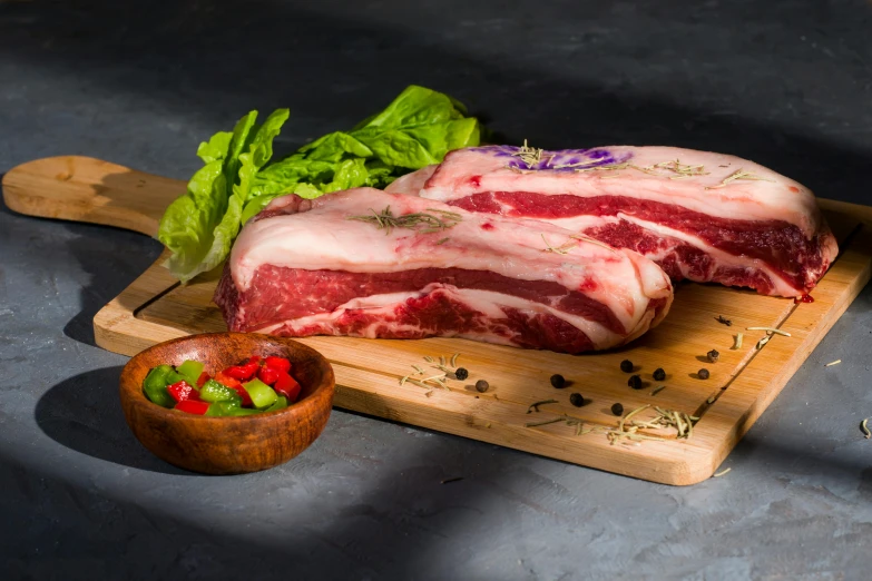 a piece of meat sitting on top of a cutting board, profile image