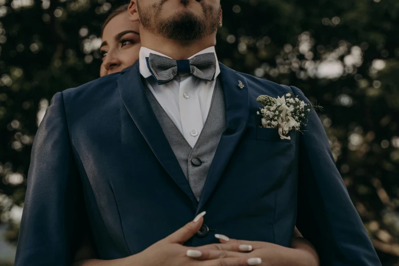 a man and a woman standing next to each other, pexels contest winner, romanticism, subject detail: wearing a suit, blue and silver, curvy and bow, 3-piece-suit