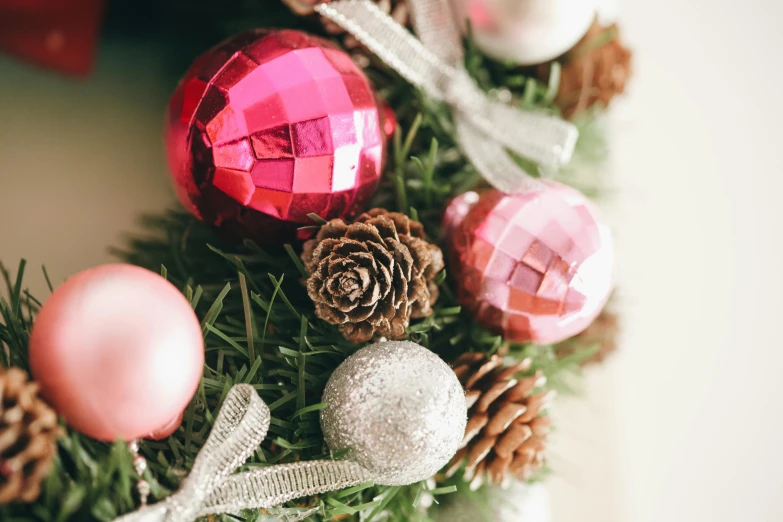 a close up of a christmas wreath with ornaments, pexels contest winner, shades of pink, pinecone, disco balls, thumbnail