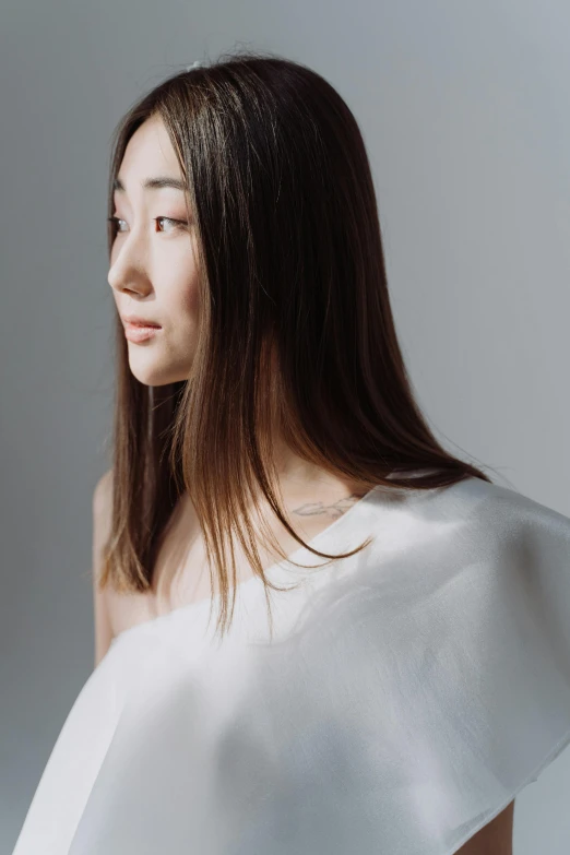 a woman with long hair wearing a white dress, inspired by Kim Tschang Yeul, trending on pexels, hyperrealism, wearing shoulder cape, issey miyake, ethnicity : japanese, smooth hair