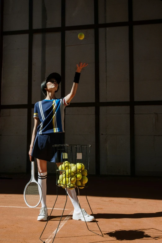 a woman standing on top of a tennis court holding a racquet, an album cover, by Julia Pishtar, unsplash, kousuke oono, ap, indoor shot, ball