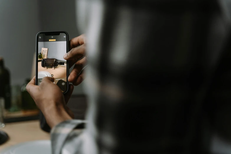 a person taking a picture with a cell phone, trending on pexels, photoshoot for skincare brand, hyperrealistic movie filmstill, shot with sigma f/ 4.2, viewed from behind