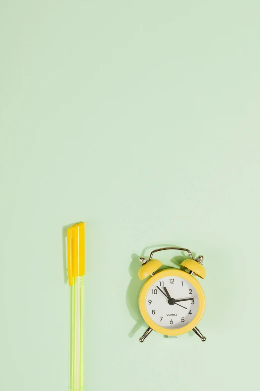 a yellow alarm clock next to a yellow toothbrush, trending on pexels, minimalism, pastel green, snacks, 1 2 9 7, pencil