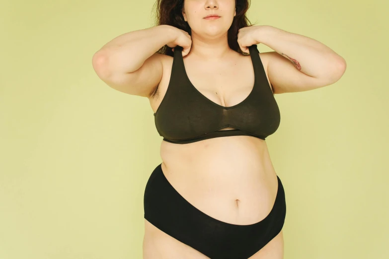 a woman in a black bikini posing for a picture, trending on pexels, renaissance, gradient from green to black, obese ), extremely pale, in kaethe butcher