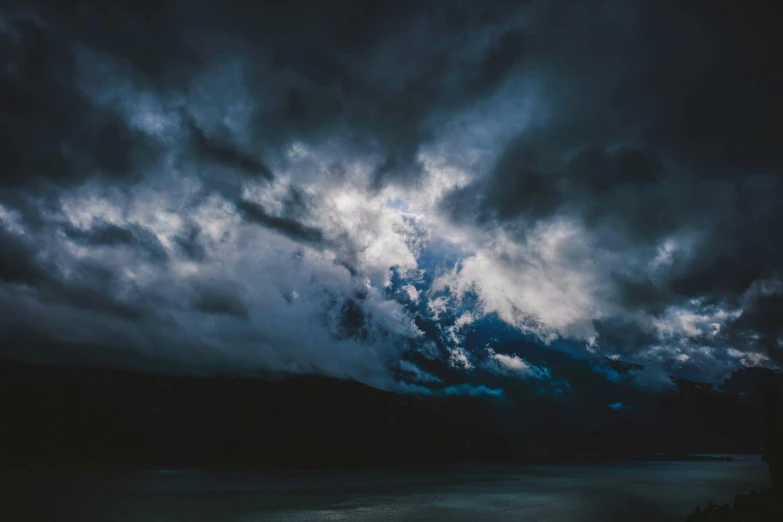 a large body of water under a cloudy sky, dark vibes, unsplash photography, horrified, instagram post