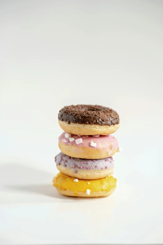 a stack of donuts sitting on top of each other, product photograph, small, low detail, multiple stories
