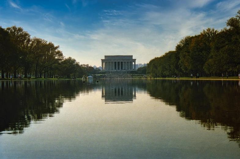 a large body of water surrounded by trees, a photo, pexels contest winner, neoclassicism, destroyed washington dc, abraham lincoln, promo image, marble reflexes