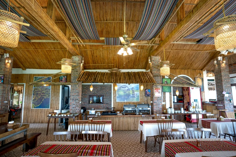 a dining room filled with lots of tables and chairs, unsplash, assam tea village background, samburu, located in hajibektash complex, profile image