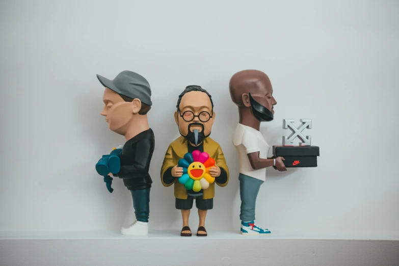 a couple of figurines sitting on top of a shelf, a statue, inspired by Okuda Gensō, pexels contest winner, ice - t portrait, weta studio and james jean, group photo, yeezy collection