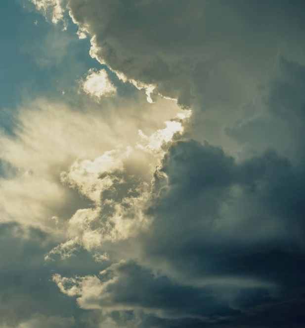 a plane flying through a cloudy blue sky, an album cover, inspired by Elsa Bleda, unsplash, romanticism, dark mammatus cloud, ignant, sun after a storm, silver lining